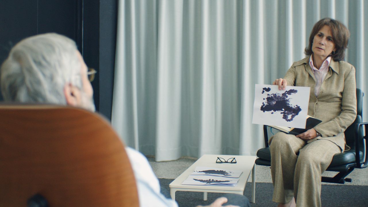 services-04 A therapist and patient in a psychotherapy session, discussing inkblot test results.